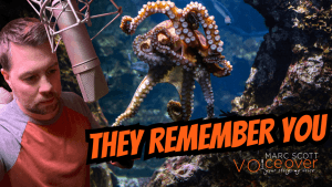 Marc Scott narrating at a microphone beside an octopus in an aquarium — thumbnail for Do Octopuses Hold Grudges, a documentary short narrated by Marc Scott